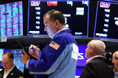 Traders work on the floor of the NYSE in New York