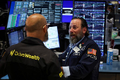 Traders work on the floor of the NYSE in New York