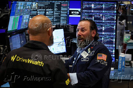 Traders work on the floor of the NYSE in New York
