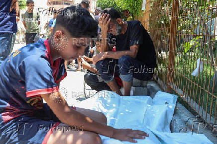Palestinians mourn loved ones killed in Israeli fire while seeking aid, at Nasser Hospital in Khan Younis, southern Gaza Strip