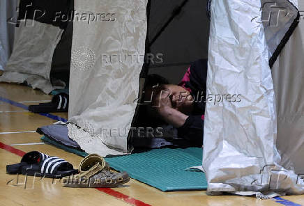 People evacuated from villages, damaged by torrential rain, rest at a temporary shelter, in Yesan,