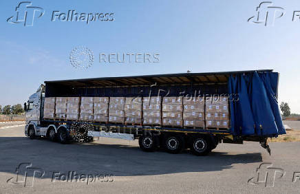 A truck carrying aid drives near the Kerem Shalom crossing between Israel and Gaza, before going into Gaza, on the Israeli side of the Israel-Gaza border