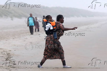 FILE PHOTO: Migrant dinghy heads off the French coast to cross the English channel