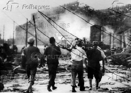 FILE PHOTO TAKEN AUGUST 1945 - Japanese men carry a victim of the atomic bomb in Nagasaki