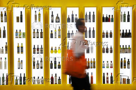 A man walks by bottles of different brands of Spanish olive oil amid the newly imposed U.S. tariffs at the 38th Gourmets Fair in Madrid