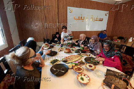 Zainab Khalifeh serves food at her home a part of which is her restaurant called 'Zainab's table' in the town of Sarafand