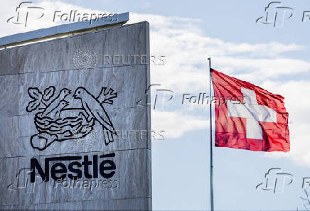FILE PHOTO: A Swiss flag flutters on the headquarters of Nestle in Vevey