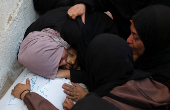 Mourners react during the funeral of Palestinians killed in overnight Israeli strikes, according to medics, at Al-Shifa hospital in Gaza City