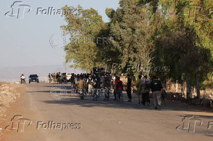Syrian Bedouin fighters gather with weapons in Deraa