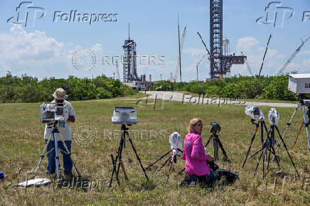 Photograhers set up remote cameras outside Launch Complex 39A before NASA?s Crew-11 mission to the International Space Station