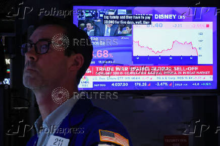 Traders work on the floor at the New York Stock Exchange, in New York