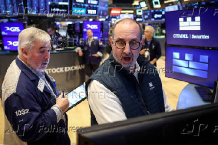 Traders work on the floor of the NYSE in New York