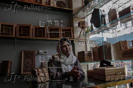 Afghan girl teach Nuristani wood carving skills at a workshop in Kabul