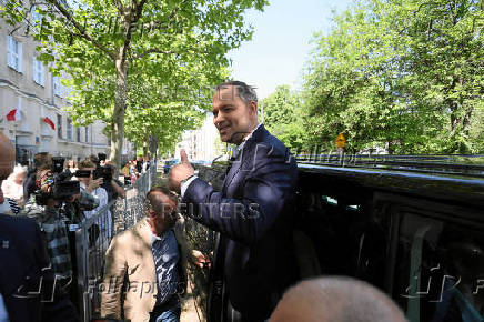Polish presidential candidate Karol Nawrocki, backed by the main opposition Law and Justice (PiS) party, gestures after he voted