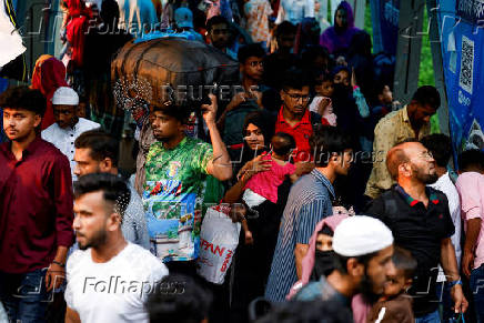 People gather at the Sadarghat Ferry Terminal to board passenger ferries, as they leave Dhaka to celebrae Eid al-Adha with their families, in Dhaka