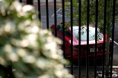 A Tesla vehicle is parked in West Executive Avenue, near the White House, in Washington