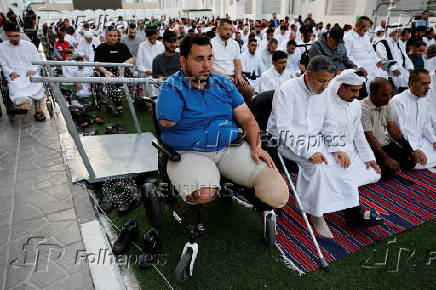 Palestinians from Gaza attend Eid al-Adha prayers, at Al Thumama Complex,  in Doha