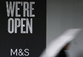 FILE PHOTO: A person walks past a branch of Marks & Spencer (M&S) food outlet in London