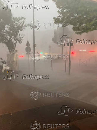 Heavy rain lashes a street during a storm in Paris