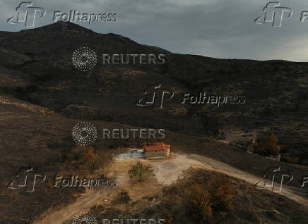 FILE PHOTO: A drone view shows a church in a burned area following a recent wildfire on Mount Penteli, near Athens