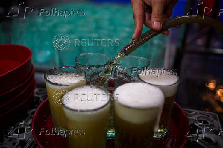 A worker pours Vietnamese draft beer 