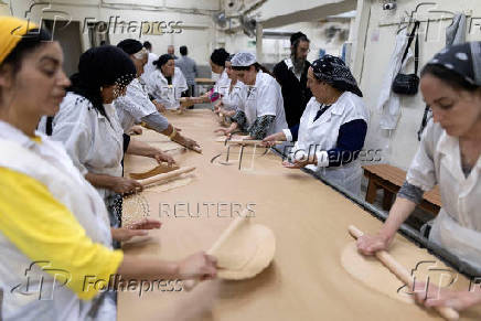 Ultra-Orthodox Jews prepare matza for the upcoming Jewish holiday of Passover