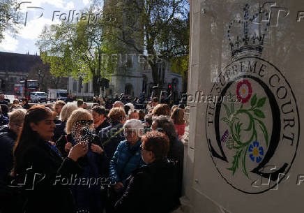 People await a ruling on an appeal by For Women Scotland outside the Supreme Court in London