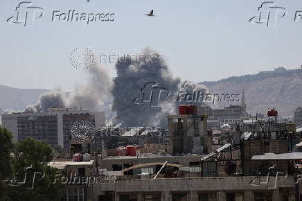 Smoke rises after strikes on Syria's defense ministry in Damascus