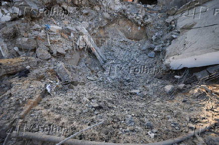 Palestinians inspect damage inside the Al-Ahli Arab Baptist Hospital in Gaza City