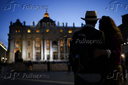 People stand at St. Peter's Square, ahead of the conclave, at the Vatican