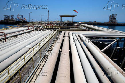 FILE PHOTO: An oil tanker is being loaded at Saudi Aramco's Ras Tanura oil refinery and oil terminal in Saudi Arabia