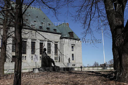 A pedestrian walks near the Supreme Court of Canada in Ottawa