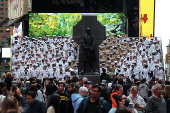 U.S. Navy sailors line up for a group portrait in Times Square during Fleet Week 2025