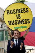 Activists of Greenpeace attend a protest near the Russian Embassy in Paris