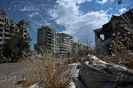 FILE PHOTO: View shows residential building damaged by Russian military strikes and anti-drone nets installed over a street in the frontline town Orikhiv