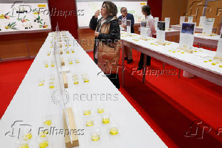 A woman samples different brands of Spanish olive oil amid the newly imposed U.S. tariffs at the 38th Gourmets Fair in Madrid