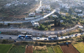 Israeli authorities encircle Palestinian town in West Bank with a fence, restricting free movement of residents