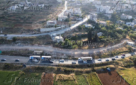 Israeli authorities encircle Palestinian town in West Bank with a fence, restricting free movement of residents