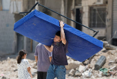 Palestinians carry their belongings after Israel's decision to demolish their homes in Nur Shams camp