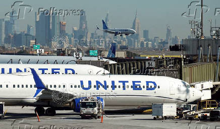 FILE PHOTO: United Airlines planes land and prepare to take off at Newark Liberty International Airport in Newark