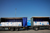 Trucks carrying aid line up at the Kerem Shalom crossing between Israel and Gaza, before going into Gaza, on the Israeli side of the Israel-Gaza border