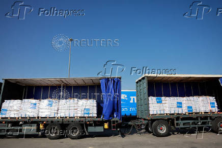 Trucks carrying aid line up at the Kerem Shalom crossing between Israel and Gaza, before going into Gaza, on the Israeli side of the Israel-Gaza border