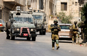 Israeli soldiers take part in an Israeli raid in Nablus