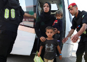 Palestinians arrive at King Hussein Bridge crossing, in South Shuna