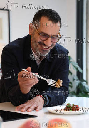 Palestinian-British chef Tamimi poses for a portrait during an interview with Reuters at his home in London