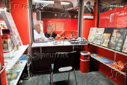 Visitors read magazines at Red History Museum in Dubrovnik