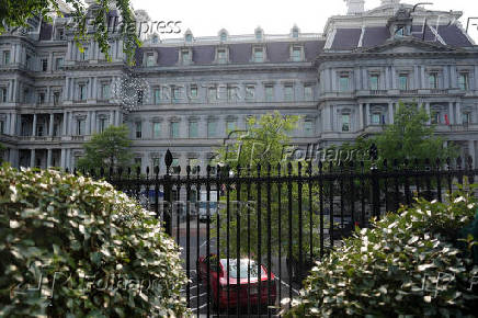 A Tesla vehicle is parked in West Executive Avenue, near the White House, in Washington