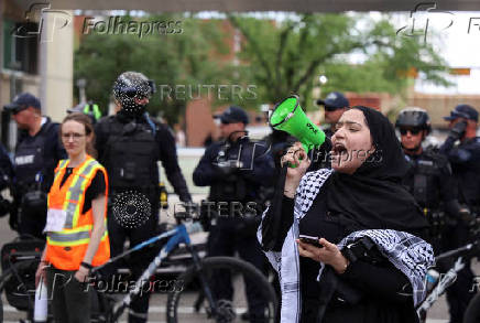 A protester demonstrates outside Calgary Municipal Building, on the first day of the G7 Leaders' Summit, in Calgary