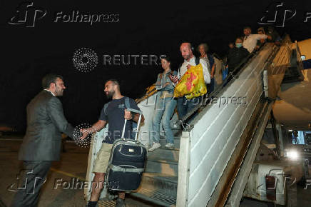 People evacuated from Israel disembark from a plane at Vasil Levski Sofia airport