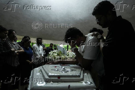 Friends and family members mourn near the coffin of Co-Pilot Clive Kunder, who died after an AIR India Boeing 787-8 Dreamliner plane crashed during take-off from an airport in Ahmedabad, in Mumbai